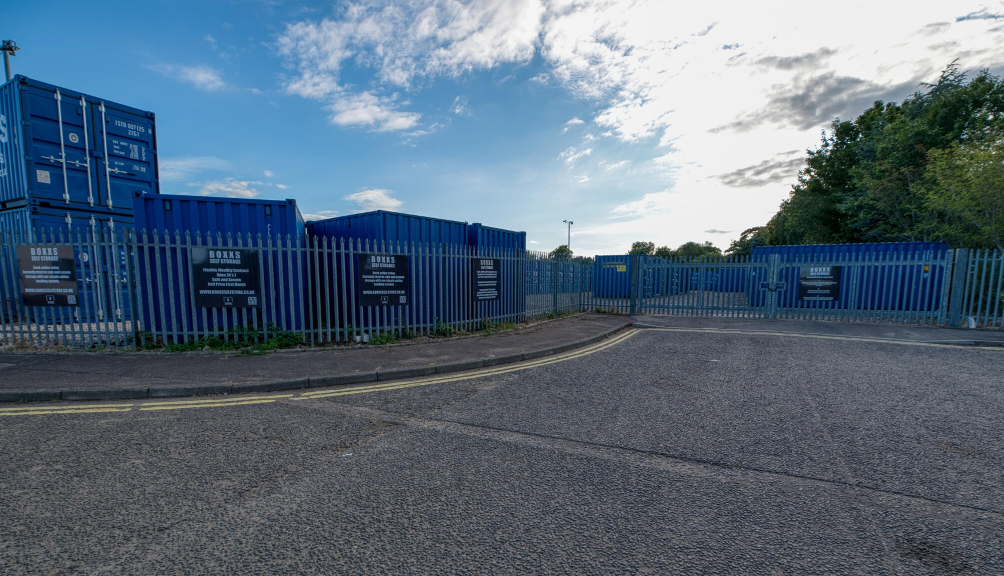 Entrance to Boxxs Self Storage Linlithgow with secure fenced yard Entrance to Boxxs Self Storage in Linlithgow showing containers, secure fenced yard, and gated access for customers